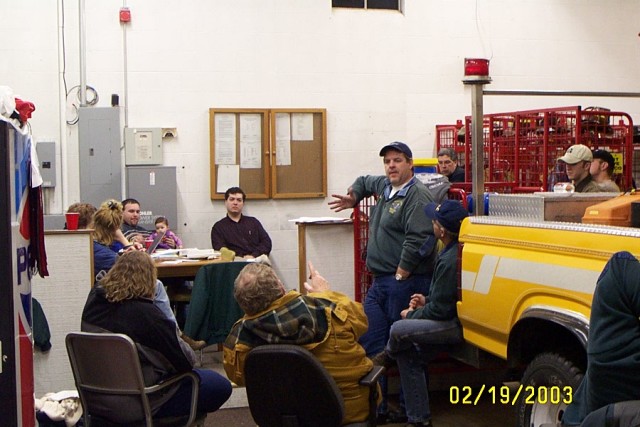 Ambulance Captain Alex Litchfield leads an ambulance meeting in the &quot;clubroom&quot; at Station 12 in 2003
